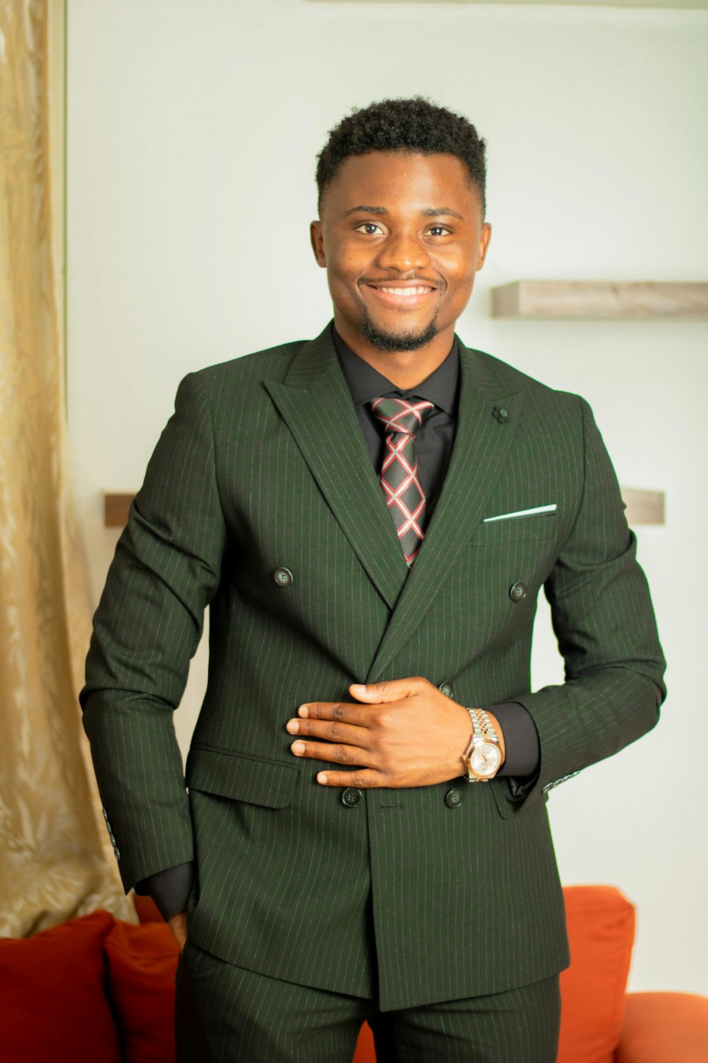 a man in a suit standing in a living room