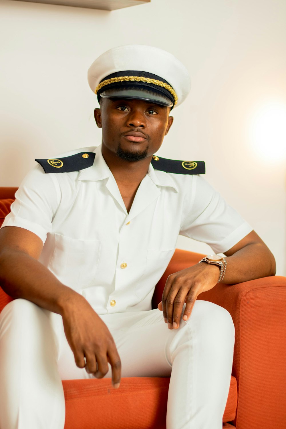 a man in a sailor's uniform sitting on a couch