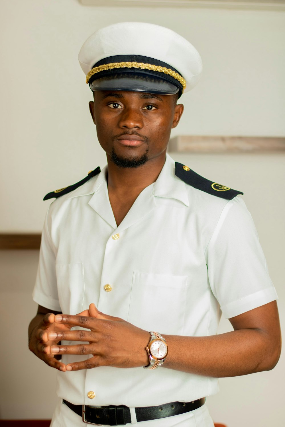 a man in a white uniform is posing for a picture