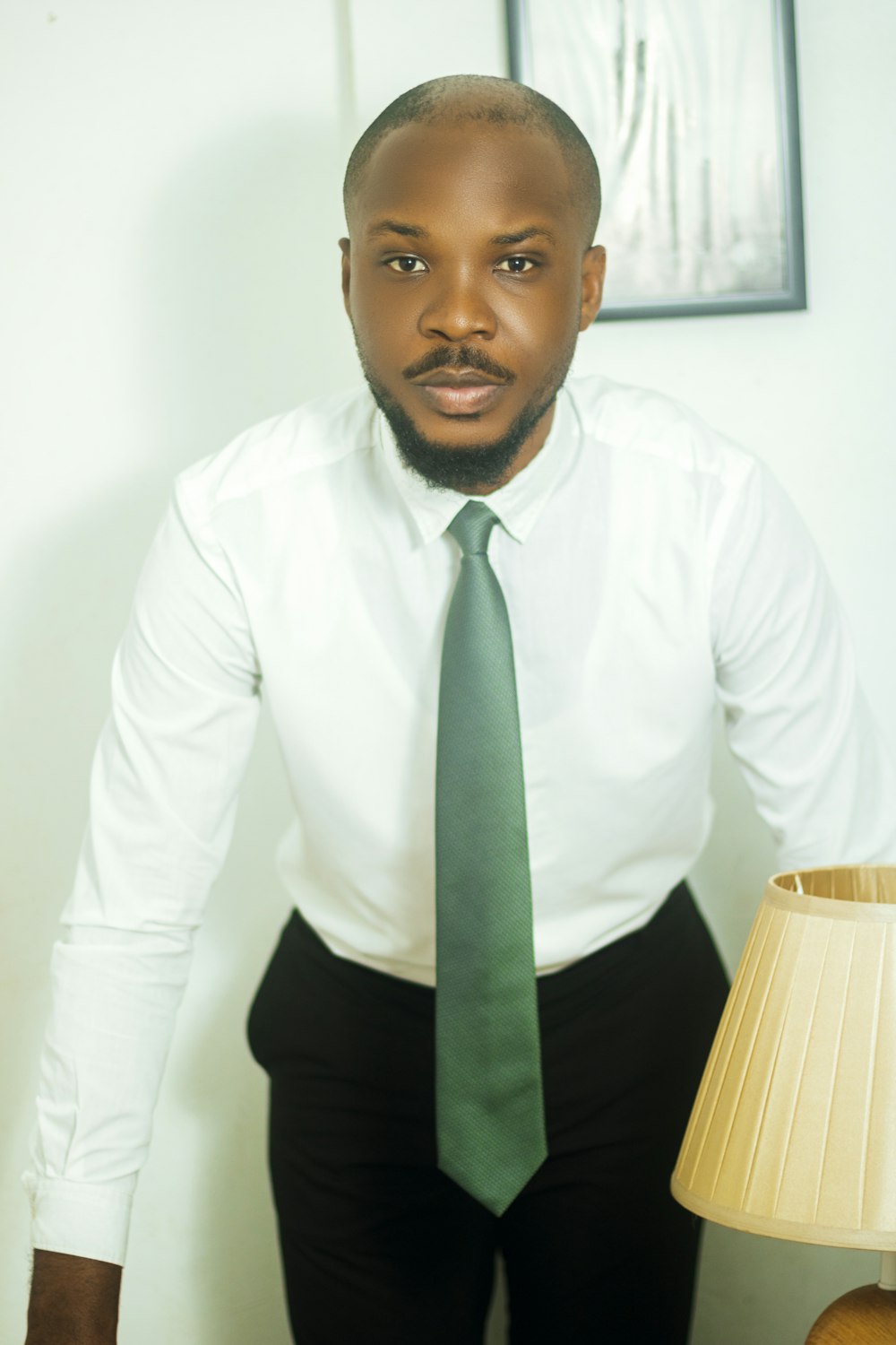 a man in a white shirt and green tie