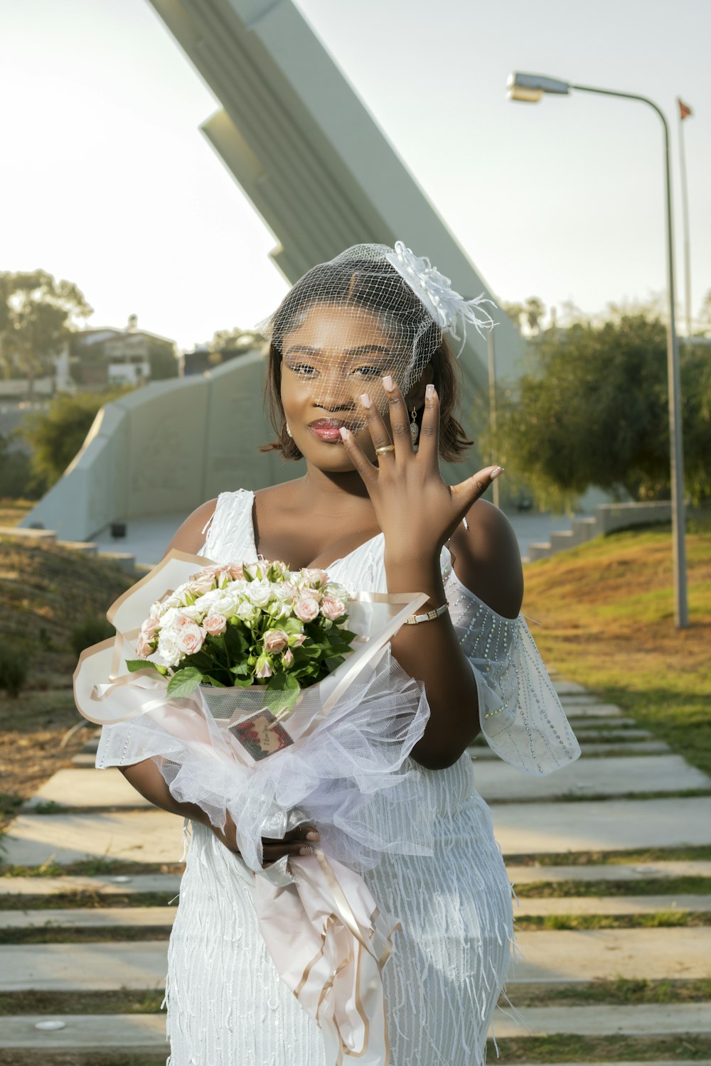 a woman in a white dress holding a bouquet of flowers