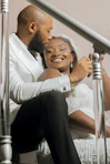 a man and a woman sitting on a stair case