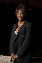 a woman wearing glasses and a black jacket