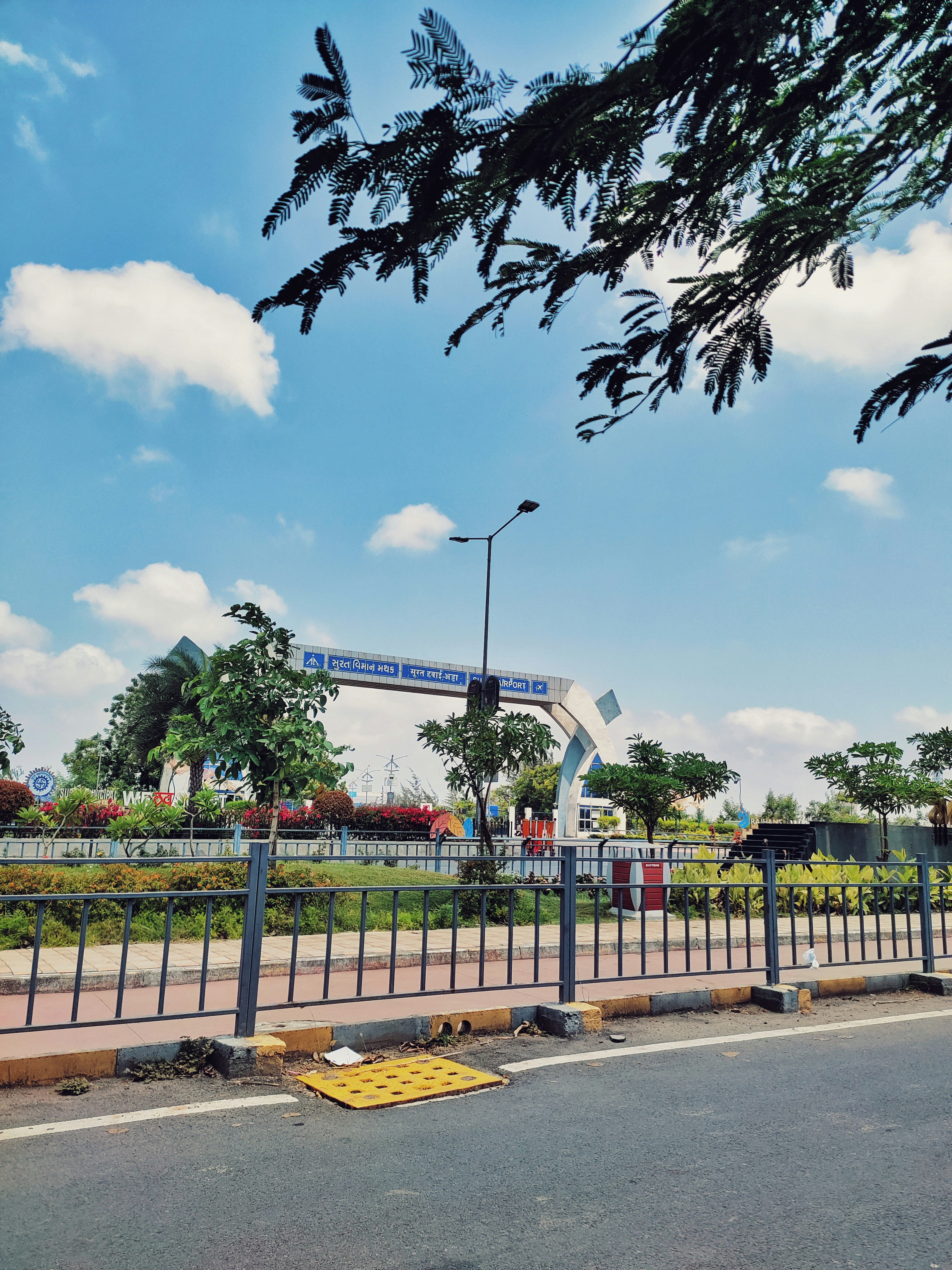 a street with a fence and a street light
