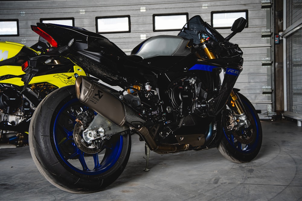 two motorcycles parked in a garage next to each other