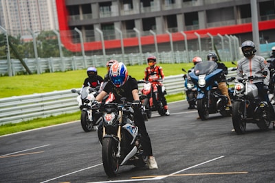 A group of riders in safety gear, preparing for a track day.
