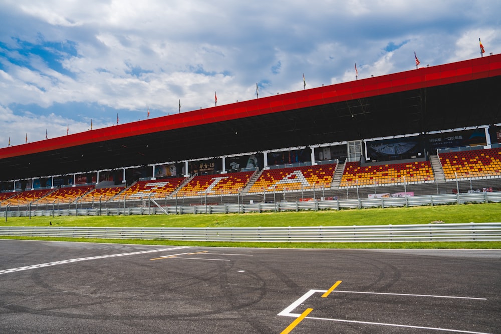 an empty race track with a red roof
