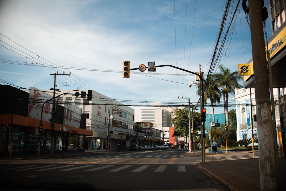 a city street with a traffic light and palm trees