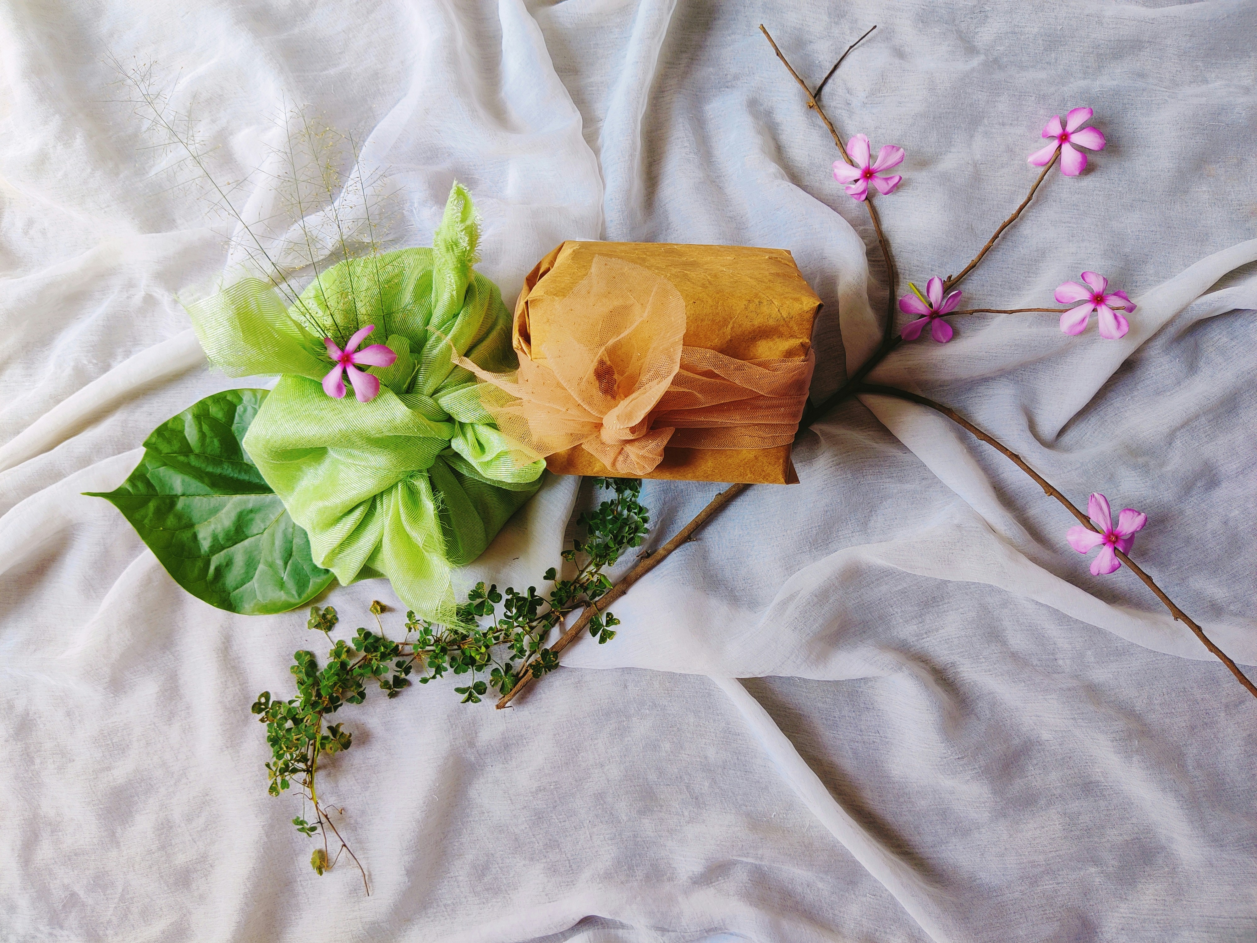 a bunch of flowers that are laying on a bed