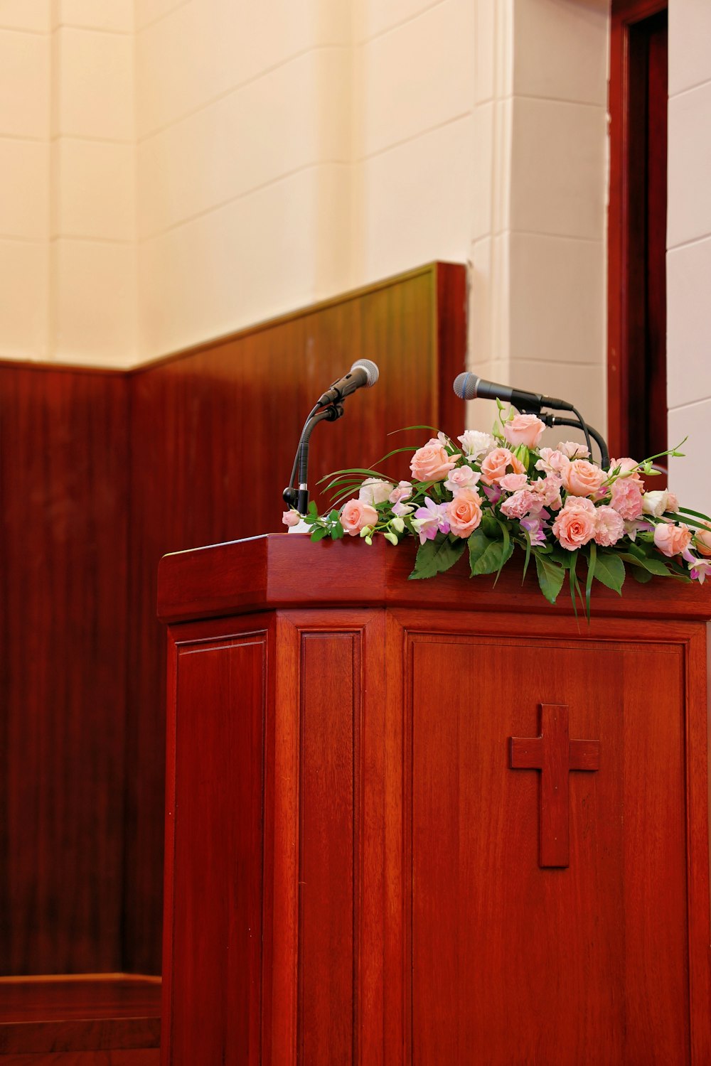 a wooden podium with flowers on top of it