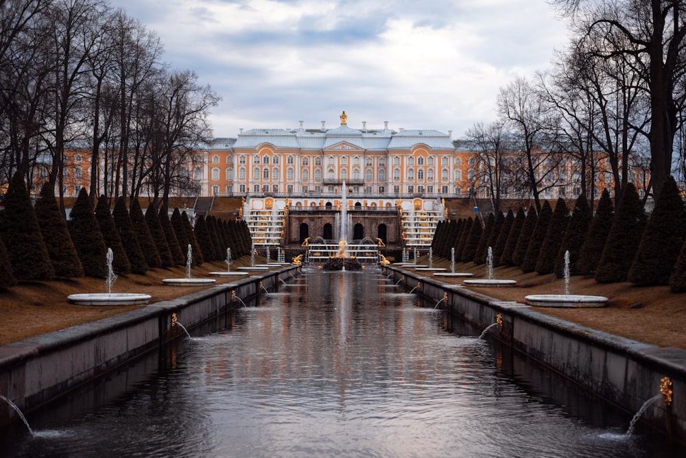 a large building with a pond in front of it