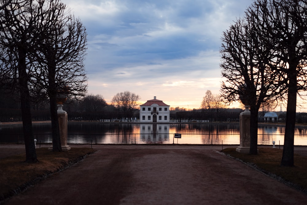 a large white house sitting next to a body of water