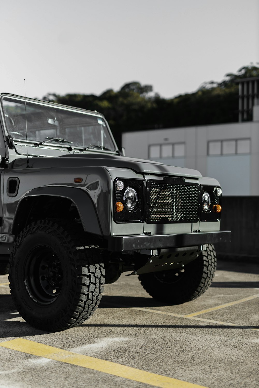 a black jeep parked in a parking lot