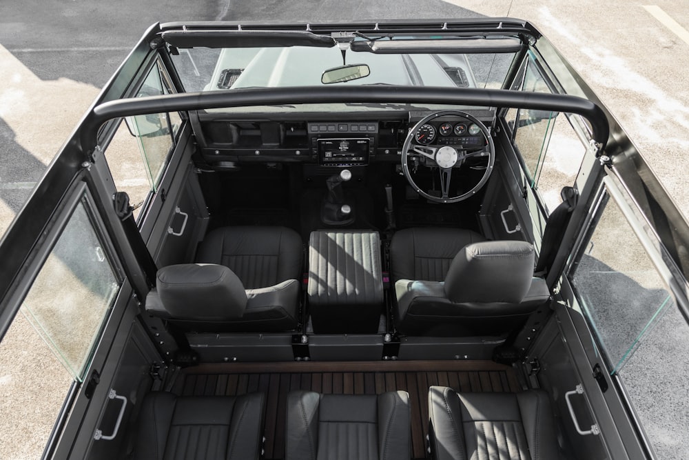 the interior of a vehicle with four seats and a steering wheel