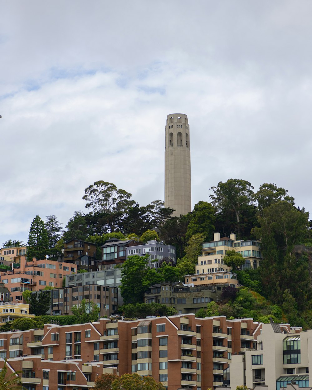 a very tall clock tower towering over a city