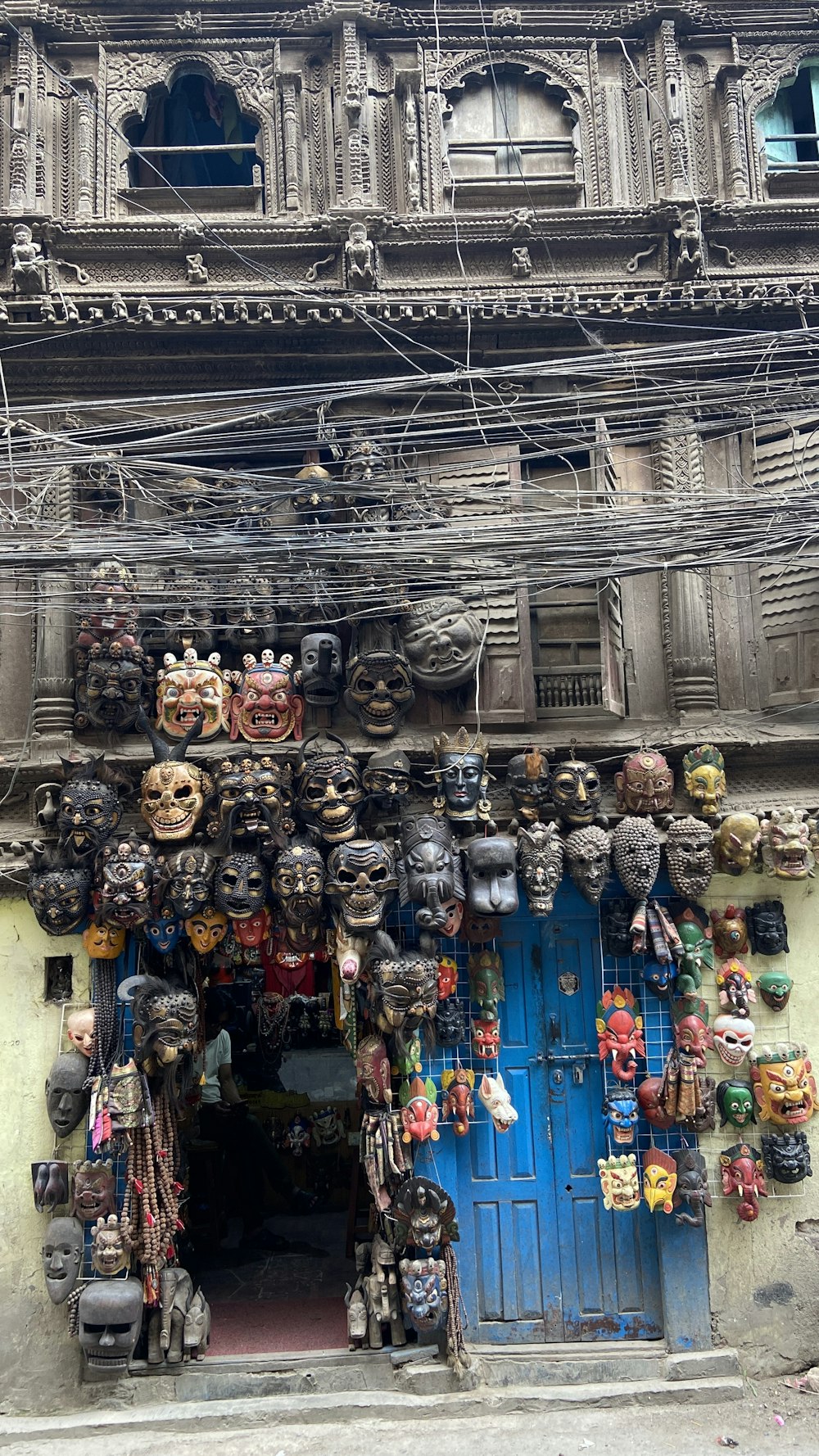 a building with a bunch of masks on the front of it