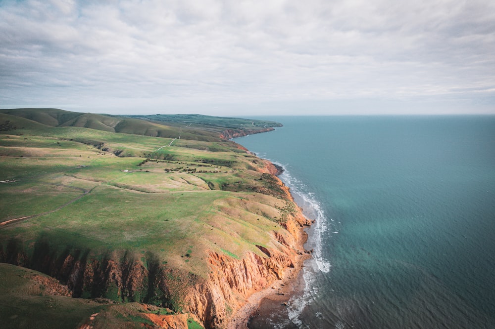 an aerial view of the ocean and land