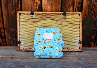 a blue backpack sitting on top of a wooden floor