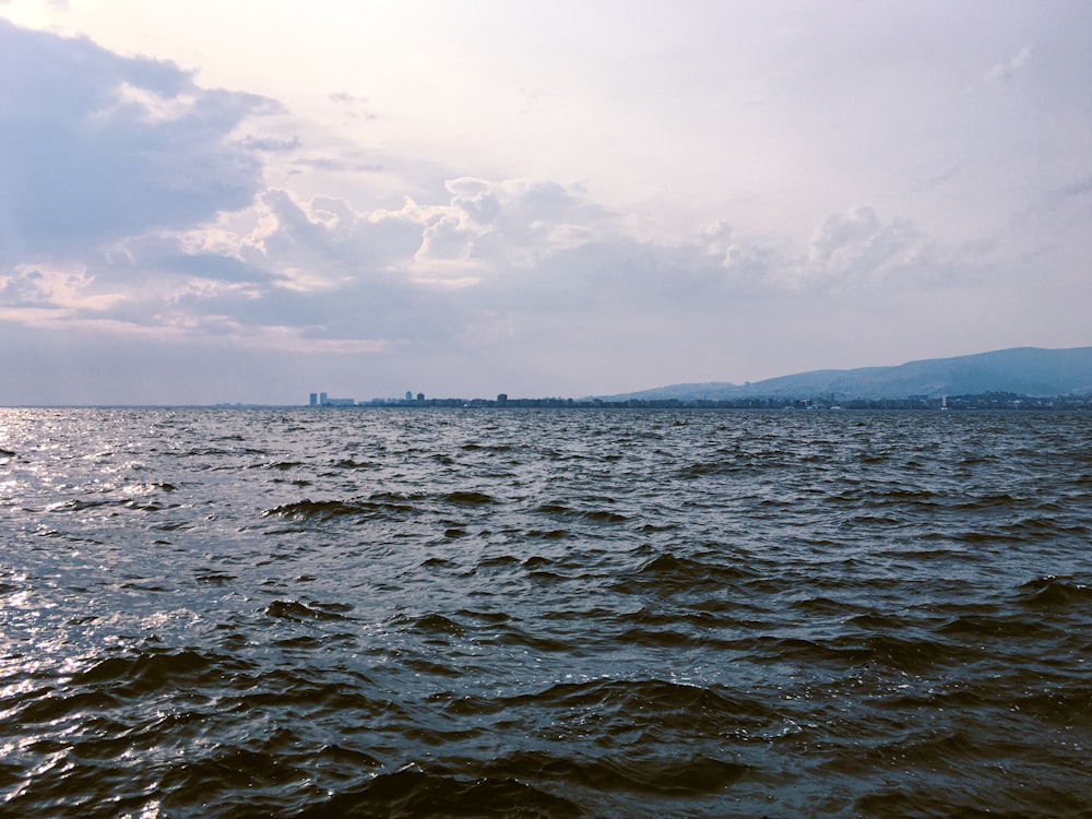 a large body of water sitting under a cloudy sky