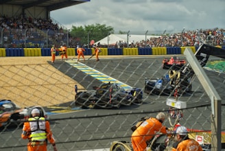 a group of people standing around a race track
