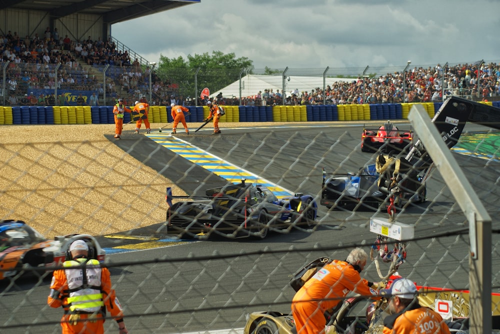 a group of people standing around a race track