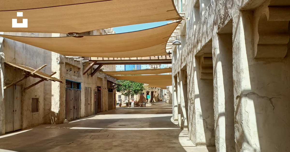 A Street Lined With Buildings And Covered In Shade Photo Free Al Seef A Street Lined With Buildings And Covered In Shade Photo Free Al Seef