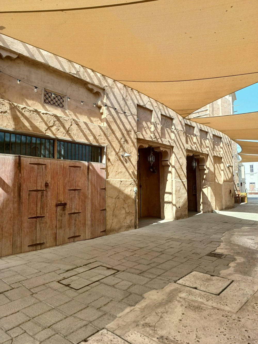 a row of wooden doors sitting on the side of a building