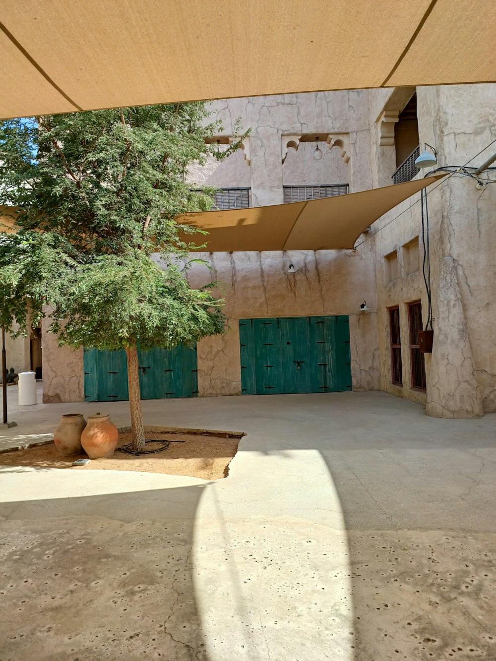 an empty courtyard with a tree in the middle