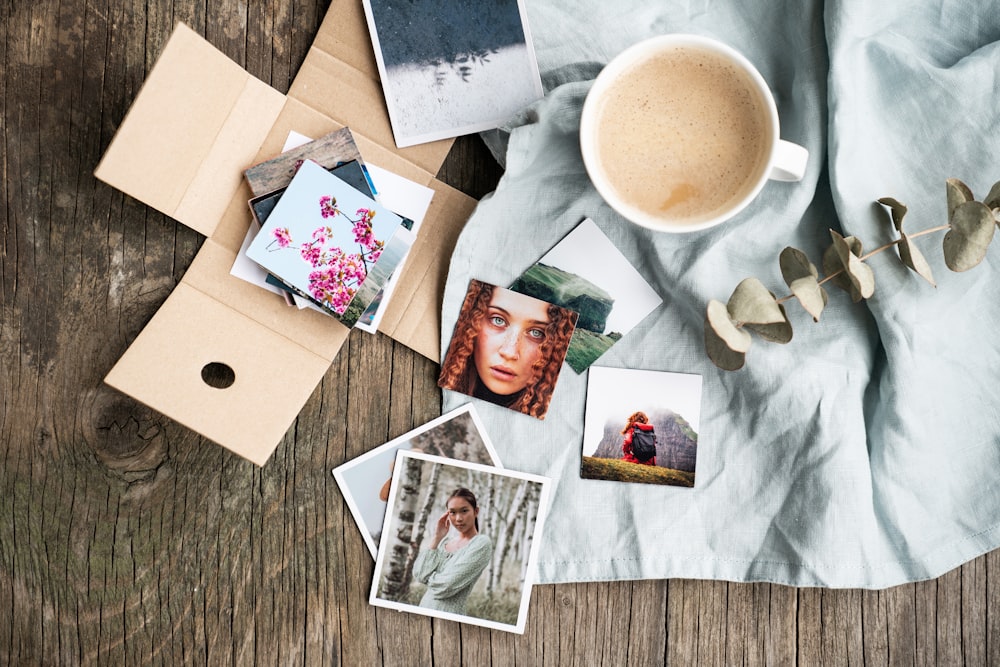 a cup of coffee sitting on top of a wooden table