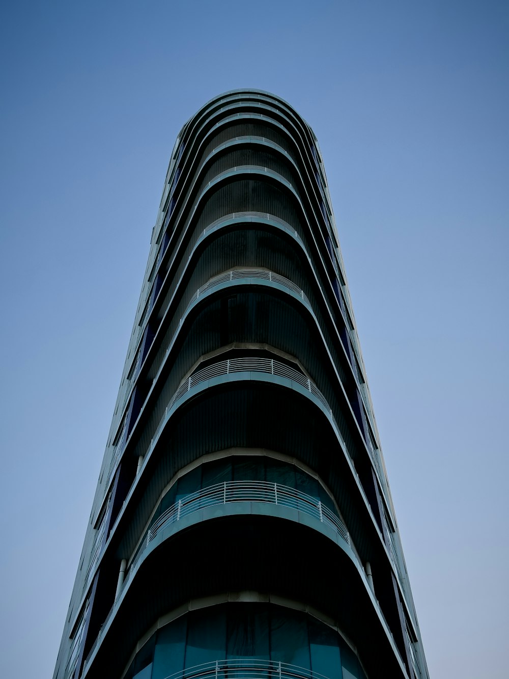 a tall building with balconies on the top of it