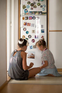 A daily routine chart pinned on a fridge with magnets, showing morning and evening tasks for kids.