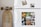 A white refrigerator decorated with multiple animal-themed photographs. The top section features two smaller images of a dog in a forest and a tabby cat. The lower section displays a collage of several animals including ducklings, a rabbit, geese, turkeys, cows, pigs, a goat, a chicken, and a horse. To the left of the fridge, a longboard with stylized text is leaning against the wall.