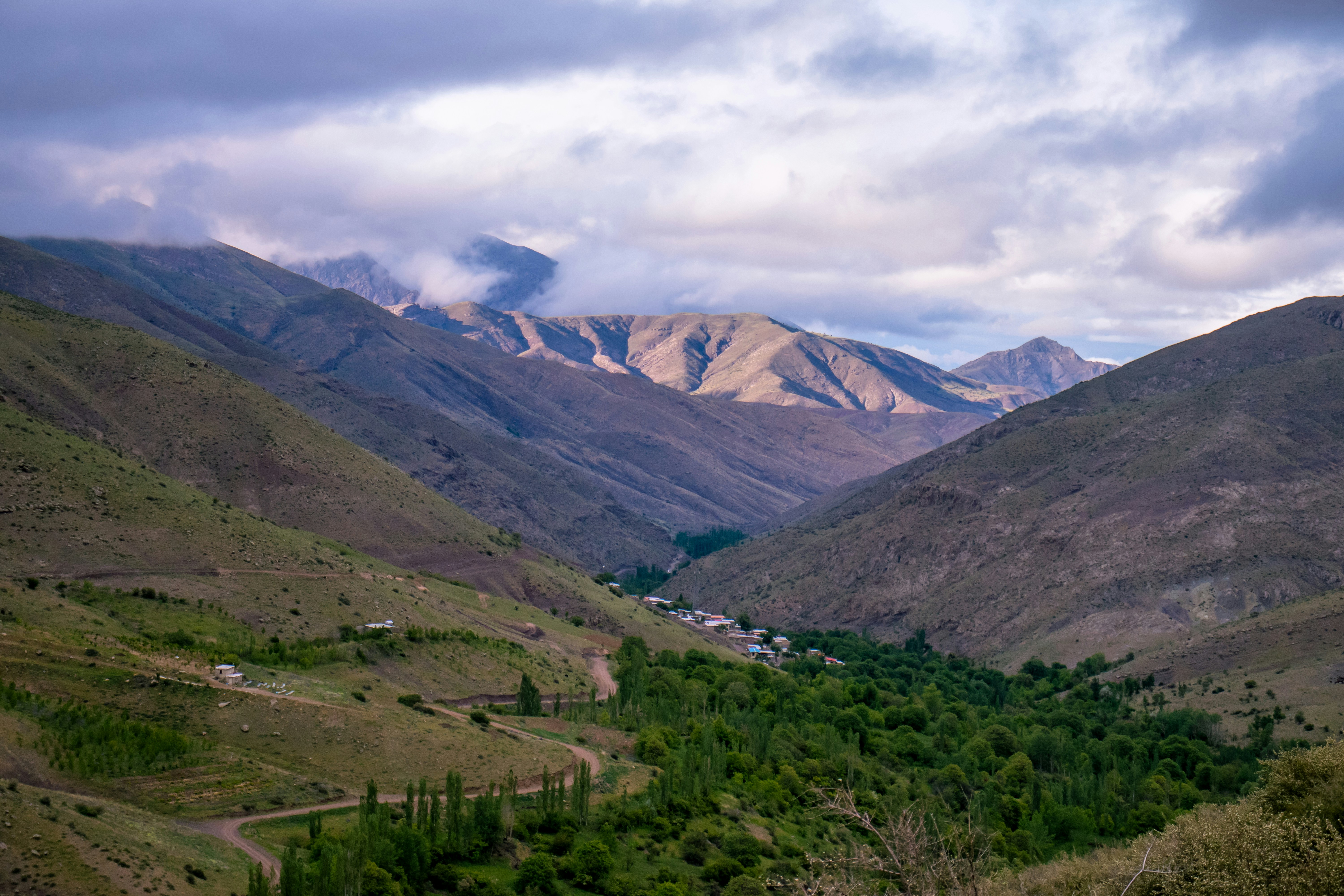a view of a valley with mountains in the background