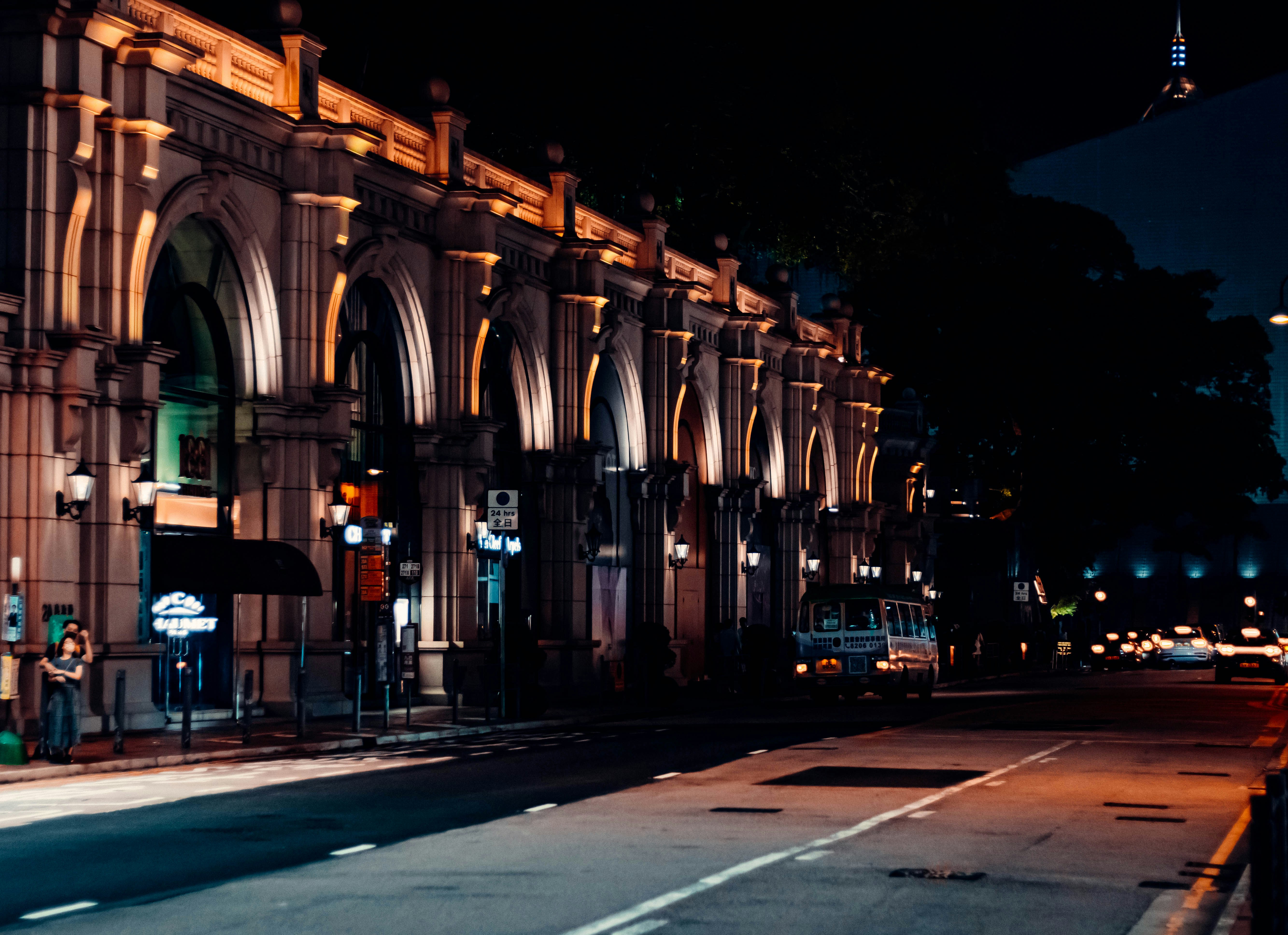 a city street at night with a building lit up, Hong Kong Architecture