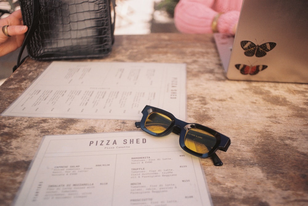 a pair of sunglasses sitting on top of a table