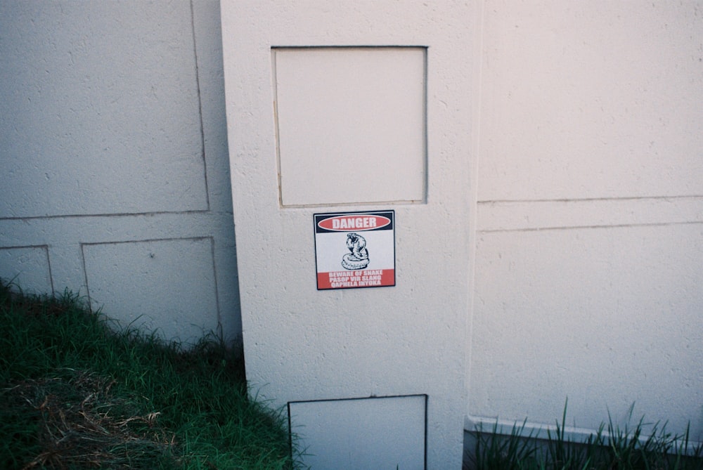 a sign on the side of a white building