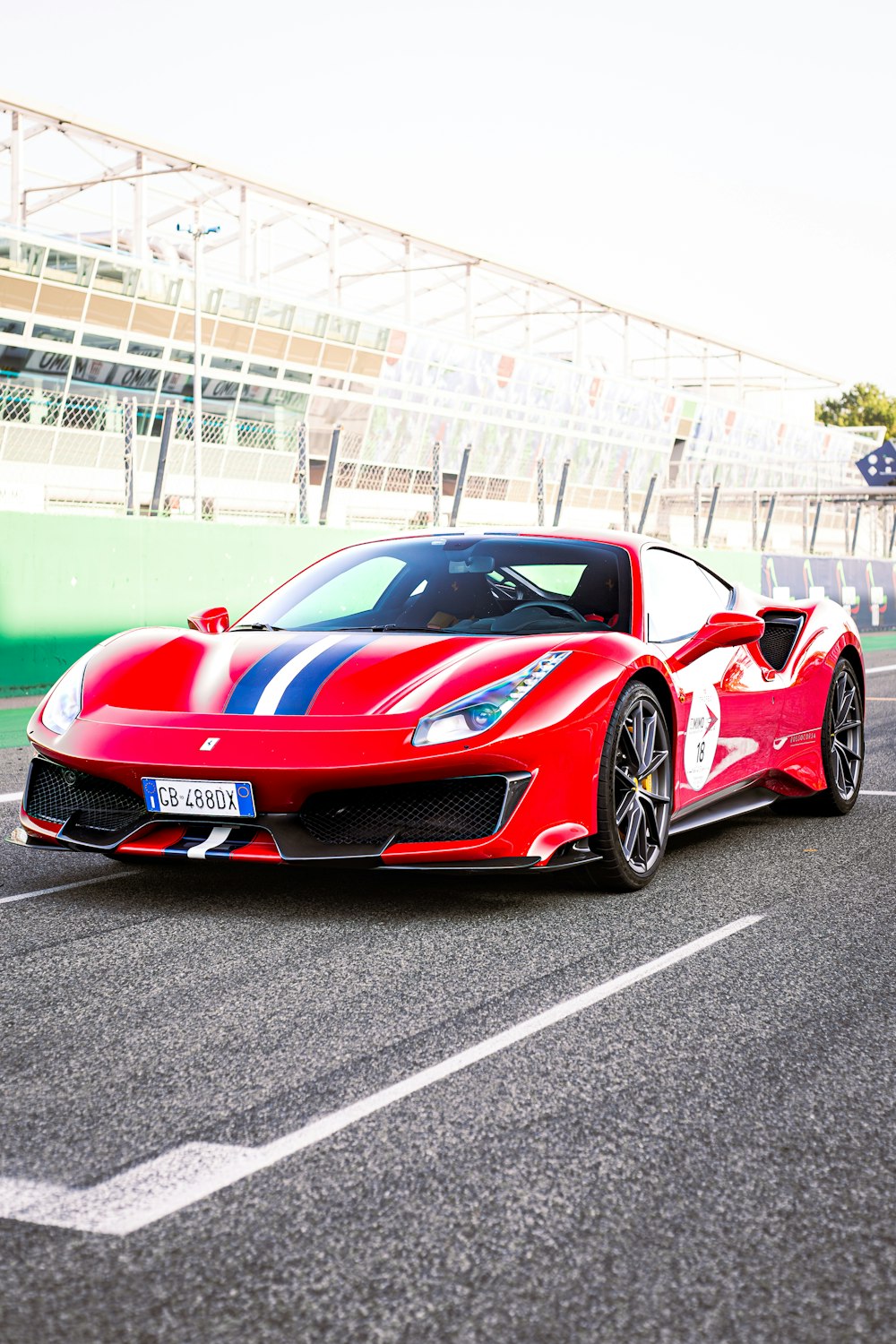 a red sports car driving down a race track