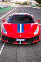 A vibrant red sports car on a racetrack.
