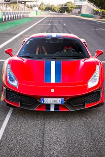 A vibrant red sports car on a racetrack.