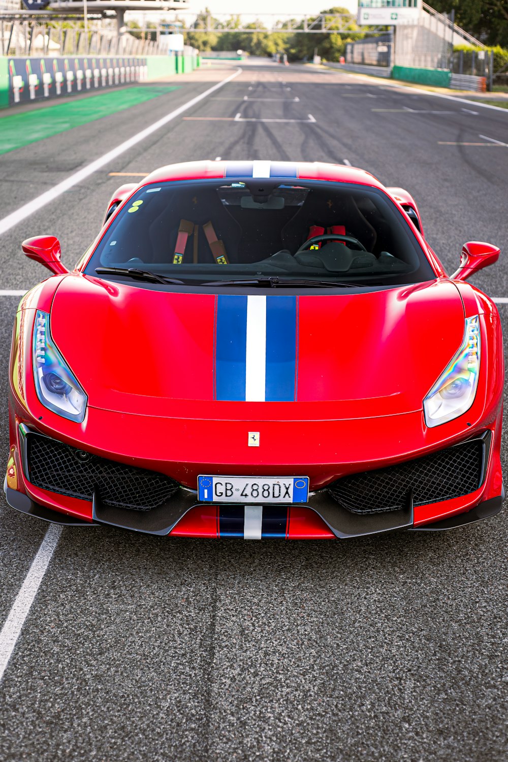 a red sports car driving down a race track