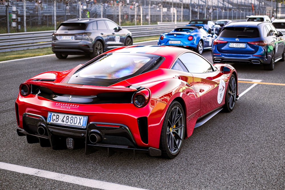 a red sports car driving down a race track