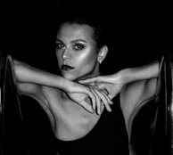 A stylish profile photo showing a model with bold makeup and a confident gaze.