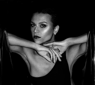 A stylish profile photo showing a model with bold makeup and a confident gaze.