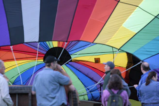 Setup crew carefully arranging an inflatable at a school event, showcasing professionalism and care.