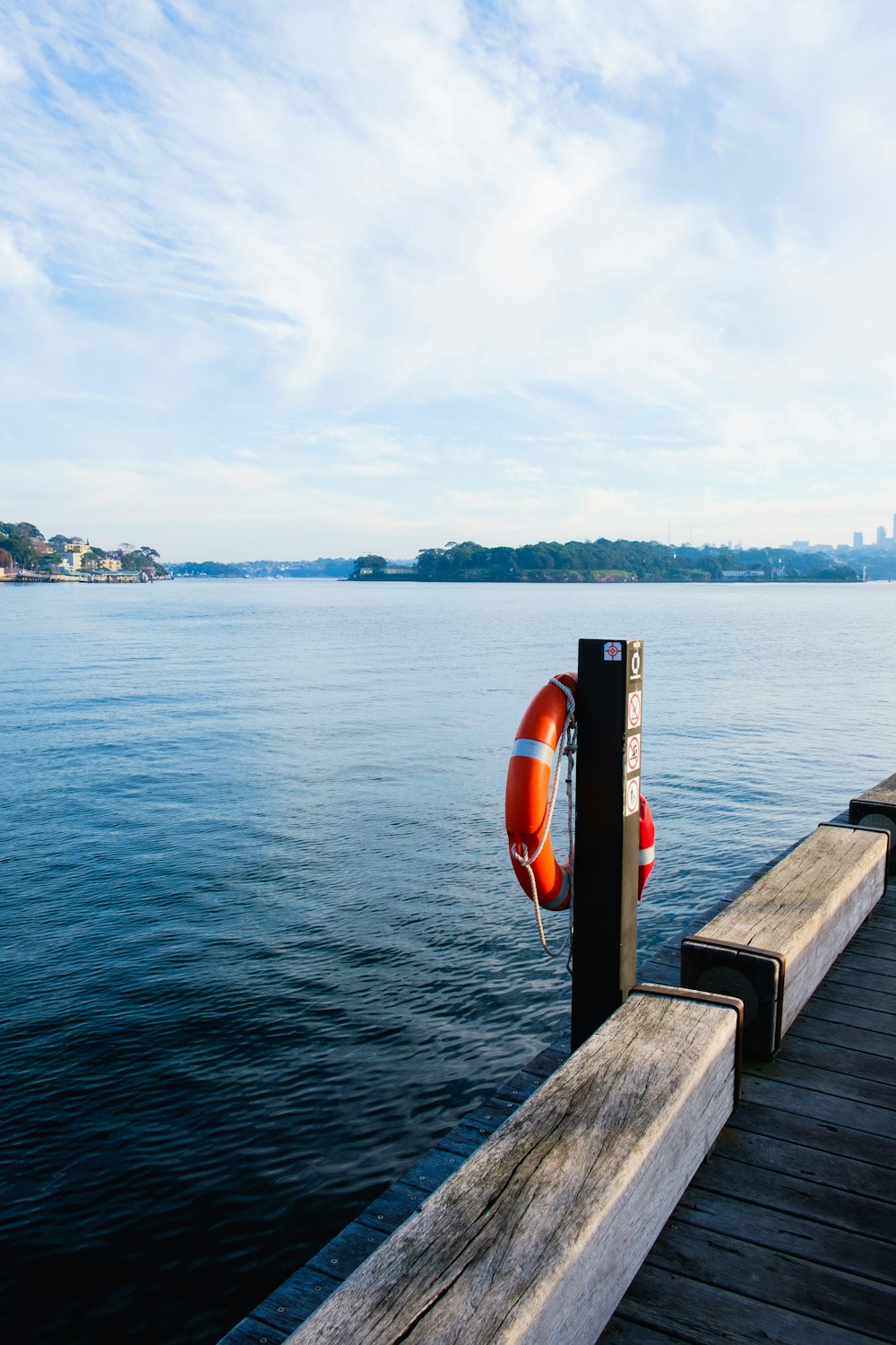 a boat tied to a dock with a life preserver