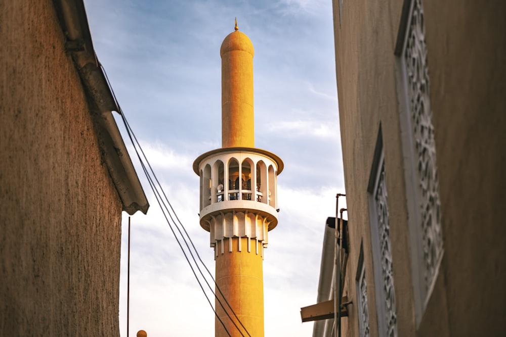 a tall building with a yellow tower on top of it