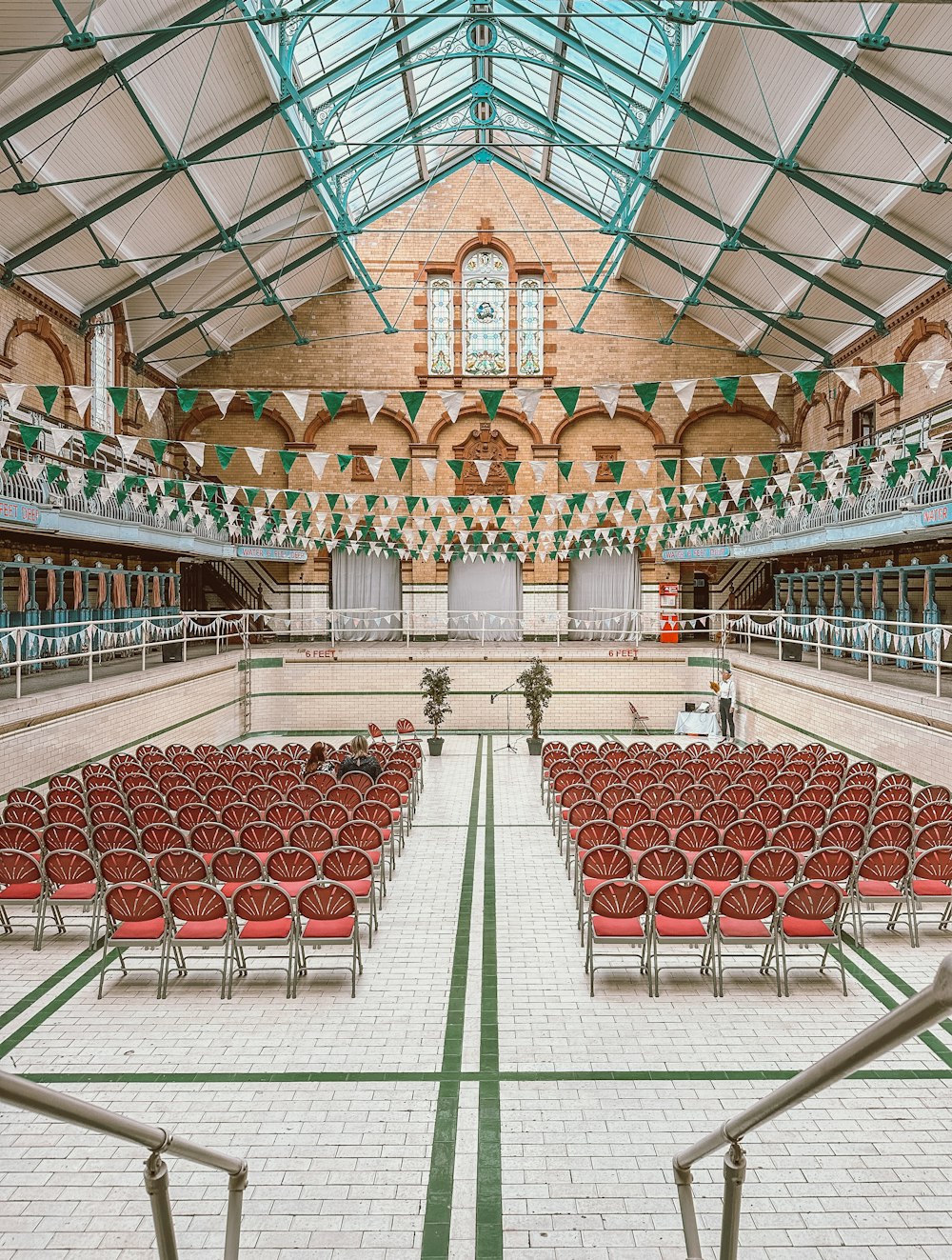 a large room filled with lots of red chairs