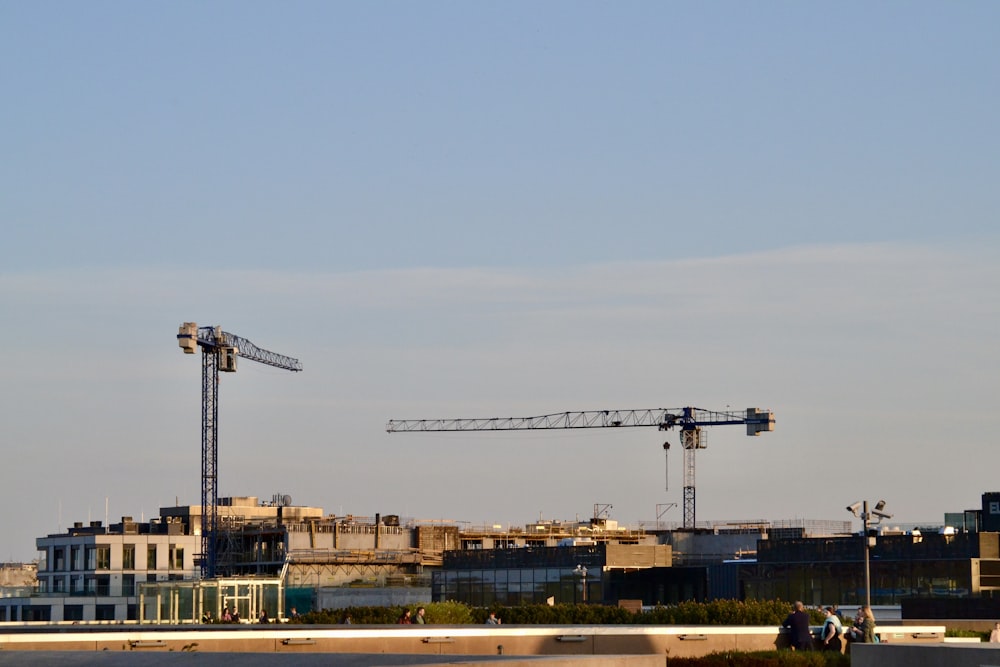 a crane is standing in front of a building under construction