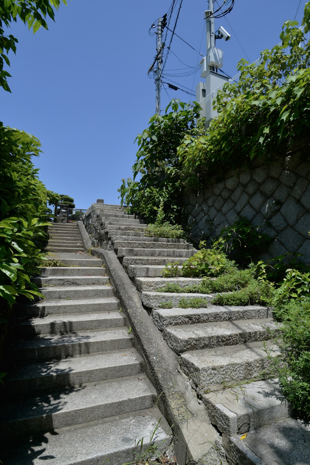 a set of stone steps leading up to a power line