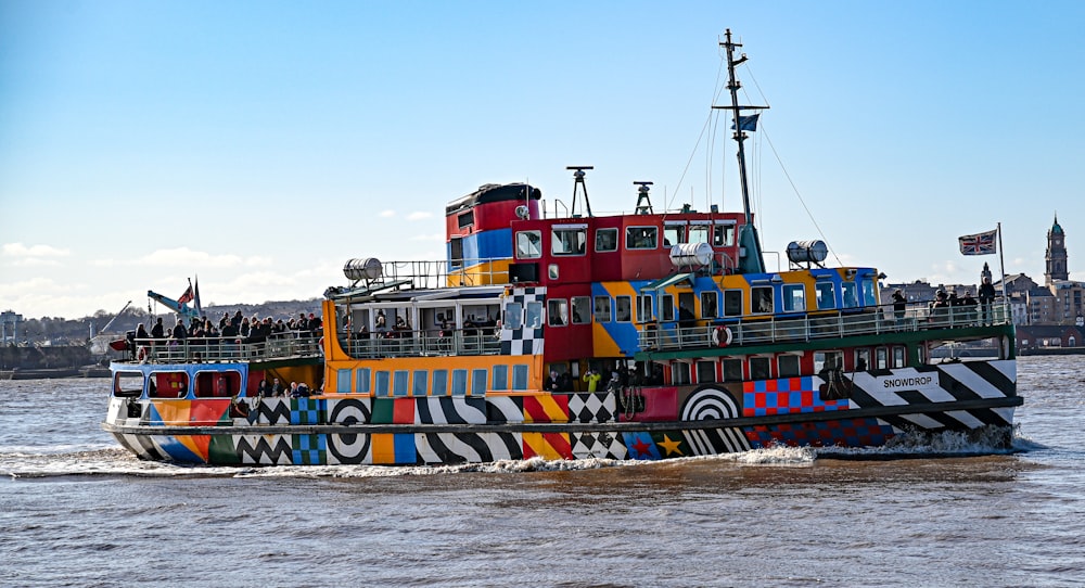 a multicolored boat traveling on the water